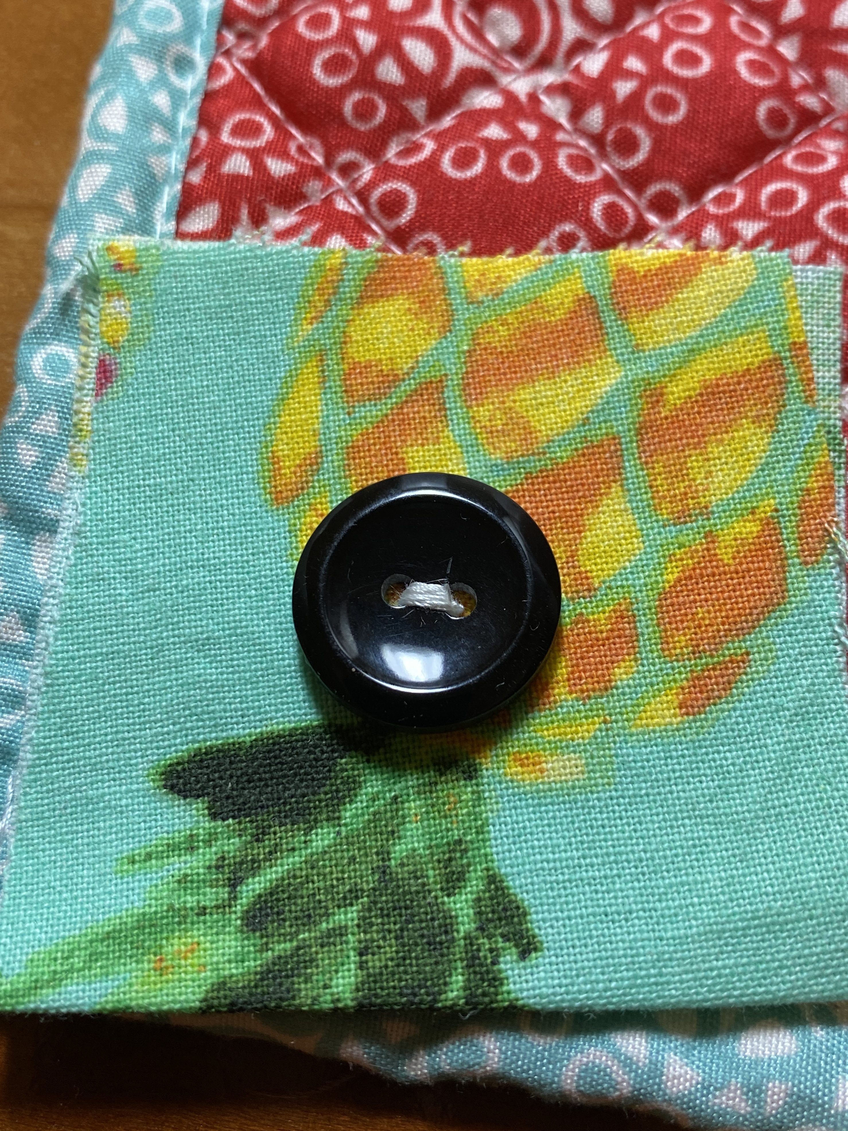 Button sewn by machine