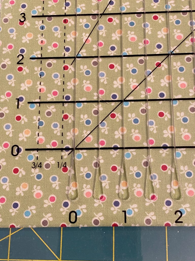 Photo showing offset lines for cutting 1/4" and 3/4" strips with June Tailor ruler. 